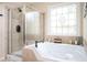 Bright bathroom featuring a large soaking tub, a separate glass-enclosed shower, and a decorative window at 455 Cooper Woods Se Ct, Smyrna, GA 30082