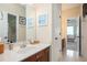 Well-lit bathroom with a single vanity, framed mirror, white countertops, and a view to another bedroom at 455 Cooper Woods Se Ct, Smyrna, GA 30082