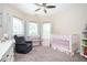 Bright Bedroom with a comfortable chair, crib, changing table, and plenty of natural light from the windows at 455 Cooper Woods Se Ct, Smyrna, GA 30082