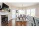 Dining room boasts a modern table, fireplace, and backyard access at 455 Cooper Woods Se Ct, Smyrna, GA 30082