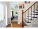 Elegant entryway with hardwood floors, staircase, and view into the living room at 455 Cooper Woods Se Ct, Smyrna, GA 30082
