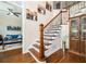 Elegant entryway with hardwood floors, staircase, and view into the living room at 455 Cooper Woods Se Ct, Smyrna, GA 30082