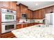 Charming kitchen with stainless steel appliances, custom cabinets, and granite countertops at 455 Cooper Woods Se Ct, Smyrna, GA 30082