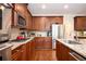 A well-equipped kitchen featuring wood cabinets, granite countertops, and stainless steel appliances at 455 Cooper Woods Se Ct, Smyrna, GA 30082