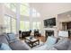 Spacious living room with large windows, fireplace and comfortable seating at 455 Cooper Woods Se Ct, Smyrna, GA 30082