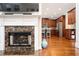 Open-concept living space with a fireplace and a view of the elegant kitchen at 455 Cooper Woods Se Ct, Smyrna, GA 30082