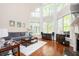 Bright living room featuring a tall wall of windows, a fireplace, and hardwood floors at 455 Cooper Woods Se Ct, Smyrna, GA 30082