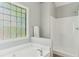 Bright bathroom with shower, tub and glass block window at 507 Mirramont Pl, Woodstock, GA 30189
