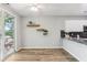 Dining area with access to outdoor deck, white cabinetry, and stylish floating shelves at 507 Mirramont Pl, Woodstock, GA 30189