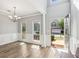 Bright dining room featuring new flooring, wainscoting, and a modern chandelier at 507 Mirramont Pl, Woodstock, GA 30189