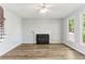 Large living room with a decorative fireplace and an abundance of natural light at 507 Mirramont Pl, Woodstock, GA 30189