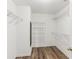 Walk-in closet with hardwood floor and wire shelving ready to organize wardrobe at 507 Mirramont Pl, Woodstock, GA 30189