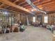 Spacious unfinished basement with concrete floor, exposed ductwork and wooden framing at 3500 Lost Valley Dr, Jonesboro, GA 30236