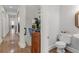 Stylish half bath features a pedestal sink, decorative mirror, and convenient location at 3500 Lost Valley Dr, Jonesboro, GA 30236