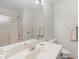 Bathroom featuring a shower with sliding doors, a white vanity, and neutral tile at 3500 Lost Valley Dr, Jonesboro, GA 30236