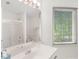 Bathroom featuring a shower with sliding doors, a white vanity and a window at 3500 Lost Valley Dr, Jonesboro, GA 30236