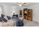 Bright bedroom with a ceiling fan, carpet, and built in shelving and display space at 3500 Lost Valley Dr, Jonesboro, GA 30236