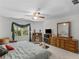 Bright bedroom with a ceiling fan, carpet, and wooden dresser and desk at 3500 Lost Valley Dr, Jonesboro, GA 30236