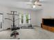Spacious bonus room with exercise equipment, ceiling fan, and exterior access at 3500 Lost Valley Dr, Jonesboro, GA 30236