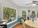 Sunny dining area features hardwood floors, large windows, and views of the outdoor scenery at 3500 Lost Valley Dr, Jonesboro, GA 30236