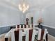 Elegant dining room with modern chandelier and seating for eight at 3500 Lost Valley Dr, Jonesboro, GA 30236