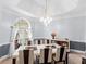 Bright and airy dining room features a tray ceiling and a modern chandelier at 3500 Lost Valley Dr, Jonesboro, GA 30236