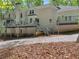Stucco home featuring a large deck and stairs that leads to a wooded backyard at 3500 Lost Valley Dr, Jonesboro, GA 30236
