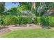 Landscaped backyard featuring a stone patio with fire pit and lush green lawn at 1216 Beech Valley Ne Rd, Atlanta, GA 30306