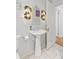 Stylish bathroom featuring a modern sink, decorative lighting, and a clean, bright ambiance with white wall paneling at 1216 Beech Valley Ne Rd, Atlanta, GA 30306