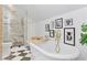 Luxurious bathroom featuring a soaking tub, marble-tiled shower, and decorative fixtures at 1216 Beech Valley Ne Rd, Atlanta, GA 30306