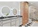 Elegant bathroom with double vanity, exposed brick, and luxurious marble shower at 1216 Beech Valley Ne Rd, Atlanta, GA 30306