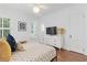 Well-lit bedroom with a comfortable bed, large windows, and a modern dresser with a TV at 1216 Beech Valley Ne Rd, Atlanta, GA 30306