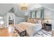Stylish bedroom with a striking light fixture, ensuite, and custom storage at 1216 Beech Valley Ne Rd, Atlanta, GA 30306