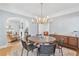 Stylish dining room with hardwood floors, designer chandelier, and views into living room at 1216 Beech Valley Ne Rd, Atlanta, GA 30306