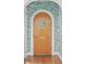 Interior view of front door with floral wallpaper, wood trim, and hardwood floors at 1216 Beech Valley Ne Rd, Atlanta, GA 30306