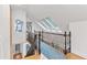 Hallway with skylights, black railing, and hardwood floors at 1216 Beech Valley Ne Rd, Atlanta, GA 30306