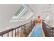 Hallway with skylights and dark wood railing overlooking the stairwell at 1216 Beech Valley Ne Rd, Atlanta, GA 30306