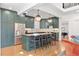Green kitchen with stainless steel appliances, island with seating, and hardwood floors at 1216 Beech Valley Ne Rd, Atlanta, GA 30306
