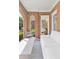 Relaxing screened porch with exposed brick, white furniture, and backyard view at 1216 Beech Valley Ne Rd, Atlanta, GA 30306