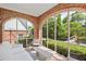 Screened-in porch with brick accents, white furniture, and serene backyard views at 1216 Beech Valley Ne Rd, Atlanta, GA 30306