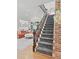 Inviting staircase with stylish carpet runner leads to the upper level, complemented by hardwood floors and a bright, open living space at 1216 Beech Valley Ne Rd, Atlanta, GA 30306