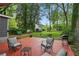 Inviting backyard with a spacious deck, lush greenery, mature trees, and outdoor seating at 1124 Larosa Sw Ter, Atlanta, GA 30310