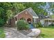 Quaint brick home with a lush green lawn and inviting porch, set in a peaceful residential neighborhood at 1124 Larosa Sw Ter, Atlanta, GA 30310
