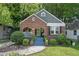 Charming brick home featuring a well-manicured lawn and inviting blue stairs leading to the front porch at 1124 Larosa Sw Ter, Atlanta, GA 30310