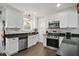 Updated kitchen featuring stainless steel appliances, white cabinets, and granite countertops at 1124 Larosa Sw Ter, Atlanta, GA 30310