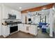 Open kitchen flows to the living room, featuring stainless steel appliances and a breakfast bar at 1124 Larosa Sw Ter, Atlanta, GA 30310