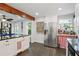 Bright kitchen with stainless steel refrigerator, granite countertops, and a red-checkered kitchen nook at 1124 Larosa Sw Ter, Atlanta, GA 30310