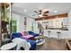 Comfortable living room featuring a large sectional sofa and an open layout to the kitchen area at 1124 Larosa Sw Ter, Atlanta, GA 30310