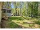 Backyard featuring a green lawn, and steps leading to a screened in porch at 1132 Luther Sw Dr, Mableton, GA 30126