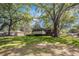 Backyard with a green lawn and views of the back of the home and surrounding trees at 1132 Luther Sw Dr, Mableton, GA 30126